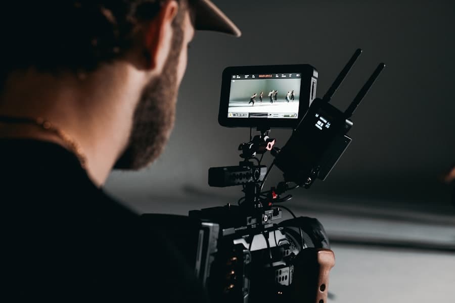 Over-the-shoulder of a creator reviewing footage on a monitor